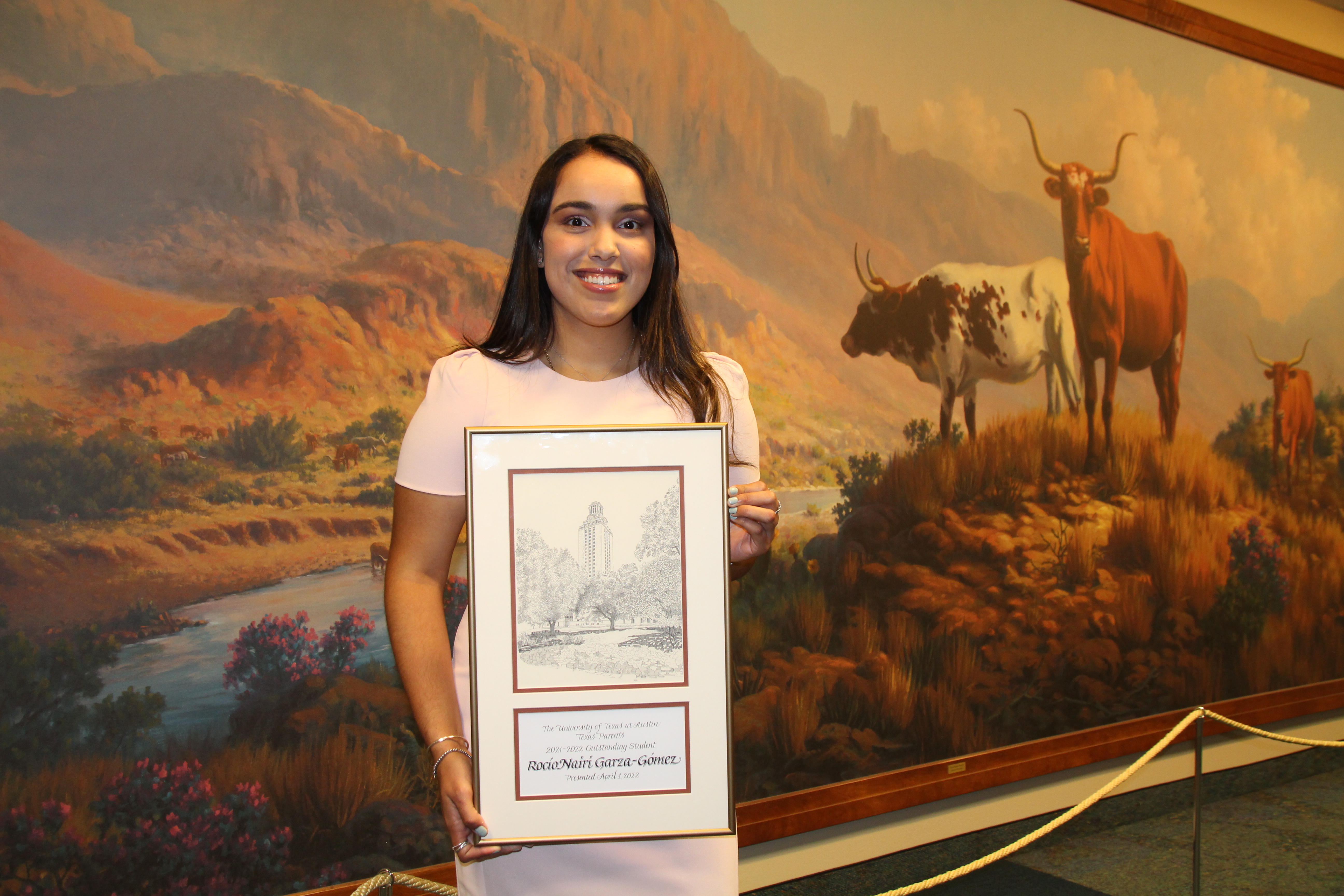 Photo of 2021-22 Outstanding Student Award Winner Rocío Nairi Garza-Gómez holding framed certificate