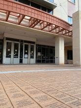 UT Austin's Student Services Building with inscribed bricks in foreground