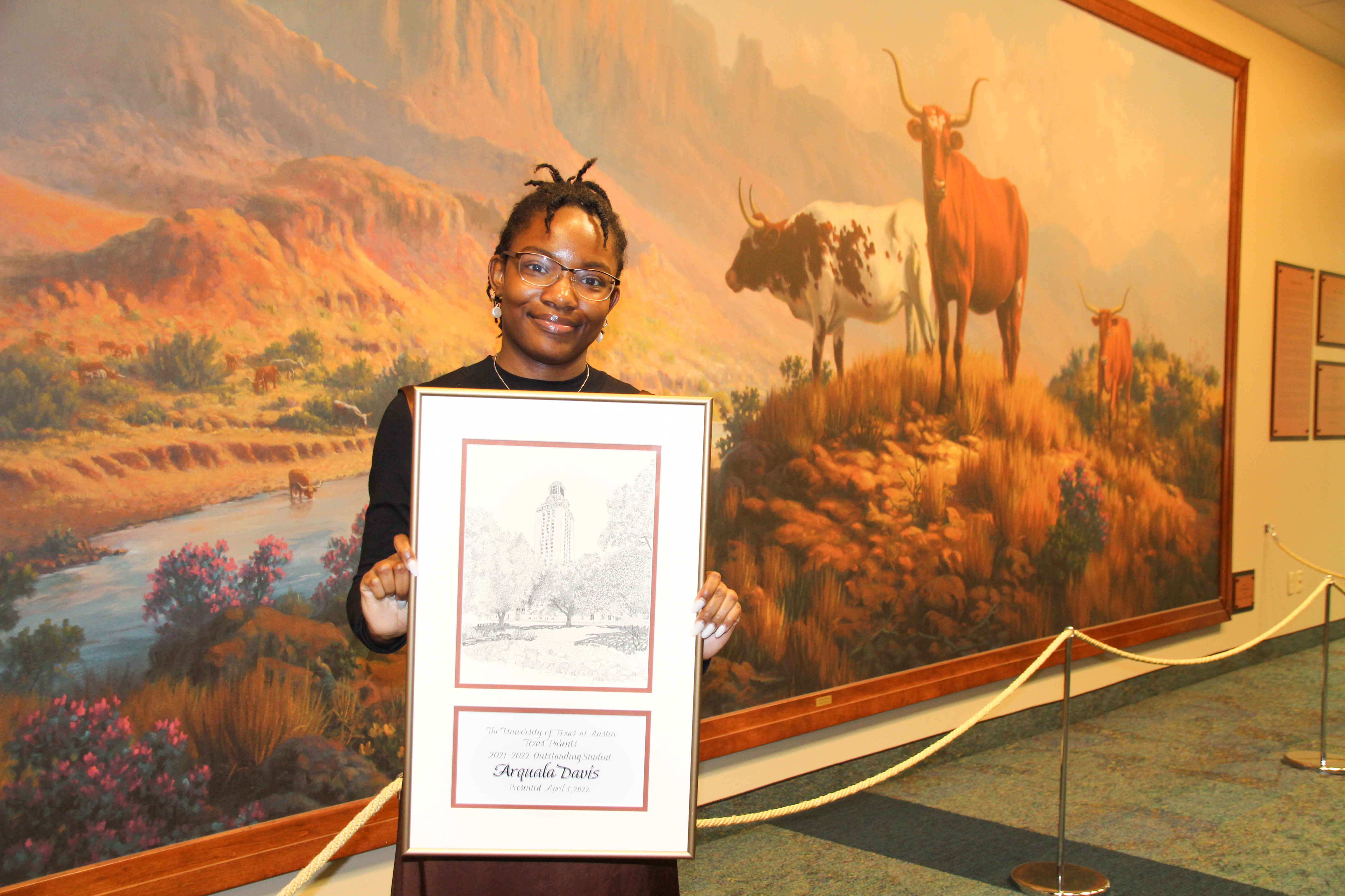 Photo of 2021-22 Outstanding Student Award Winner Arquala Davis holding framed certificate